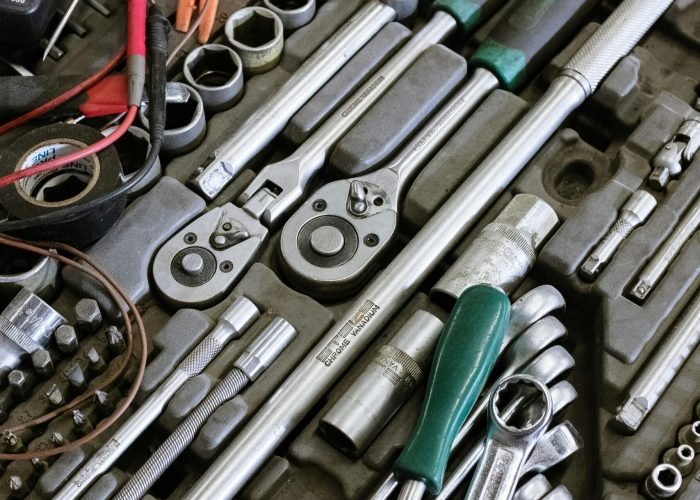 Detailed photo of various mechanic tools organized in a workshop setting. Perfect for repair themes.